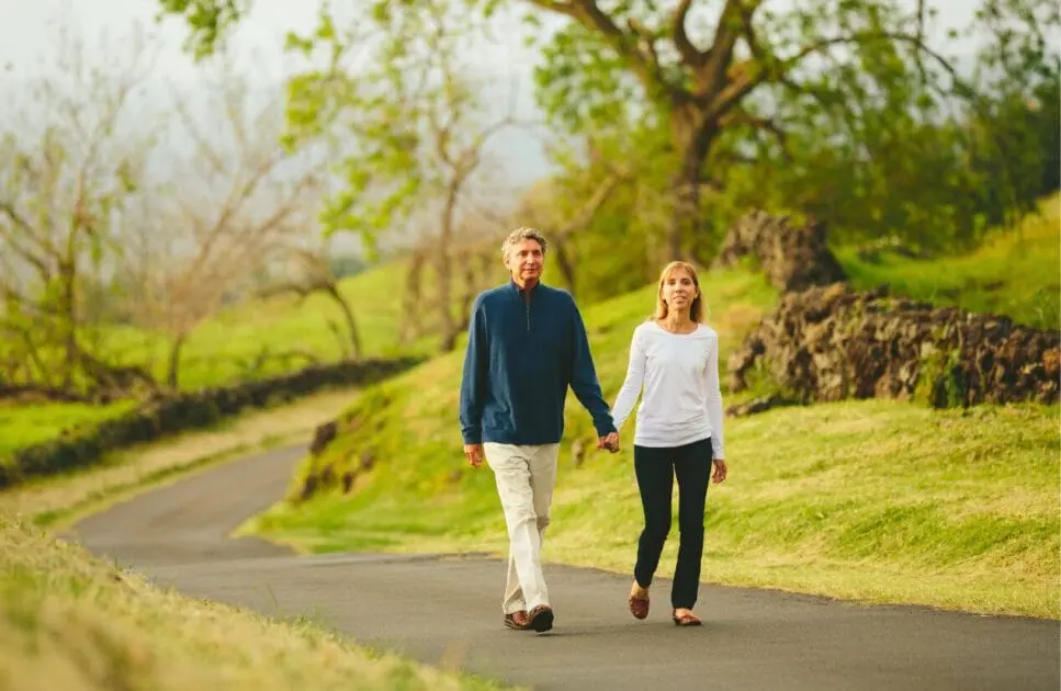 Couple walks hand in hand along road, surrounded by nature. Marriage Counselling. Brisbane. Bridgeman Downs. MTHFR Gene Test. Osteopath for Knee Pain. Brisbane Livewell Clinic