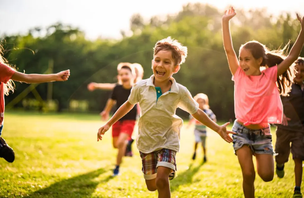 Happy children running in nature. Counselling Kedron. Brisbane Livewell Clinic