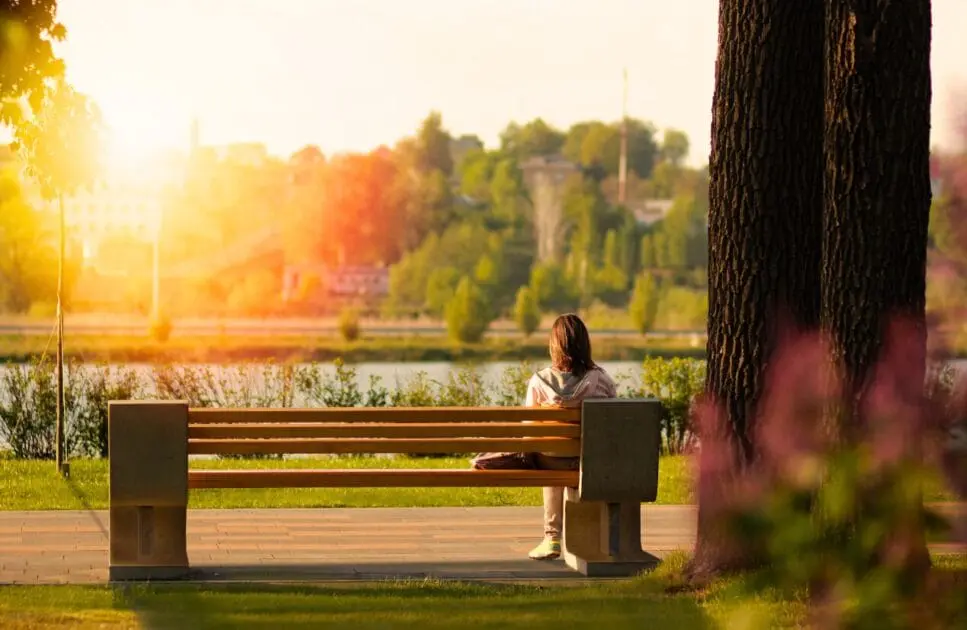 Woman sitting on a bench near the body of water. Genetic Methylation Test. Iron Deficiency. Brisbane Livewell Clinic