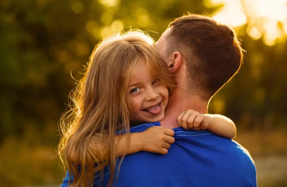 Daughter makes a funny face while hugging her father. Hypnotherapy near Clayfield. Brisbane Livewell Clinic