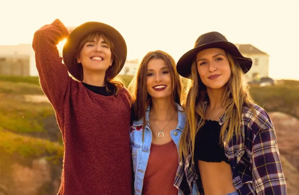 Three smiling young women are posing outdoors. Genetic Methylation Test. Women's Health. Brisbane Livewell Clinic
